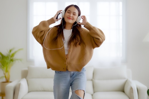 Woman listening to music in living room